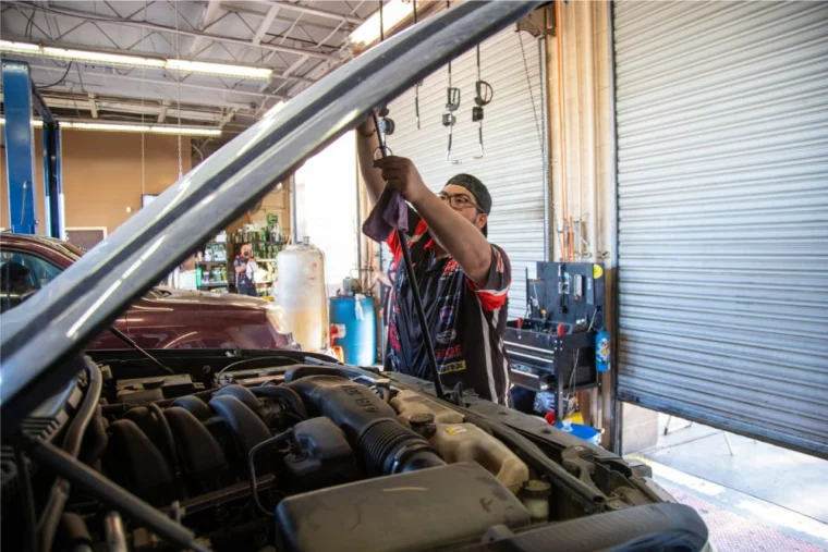 Grease Monkey Phoenix technician working under the hood of a car