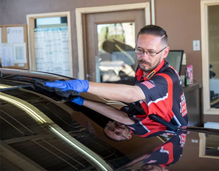 Grease Monkey Phoenix team member inspecting windshield during service