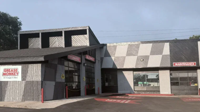 Renovated exterior of Grease Monkey oil change center with updated signage, fresh paint, and modern branding.