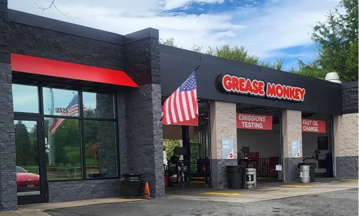 Renovated exterior of Grease Monkey oil change center with updated signage, fresh paint, and modern branding.
